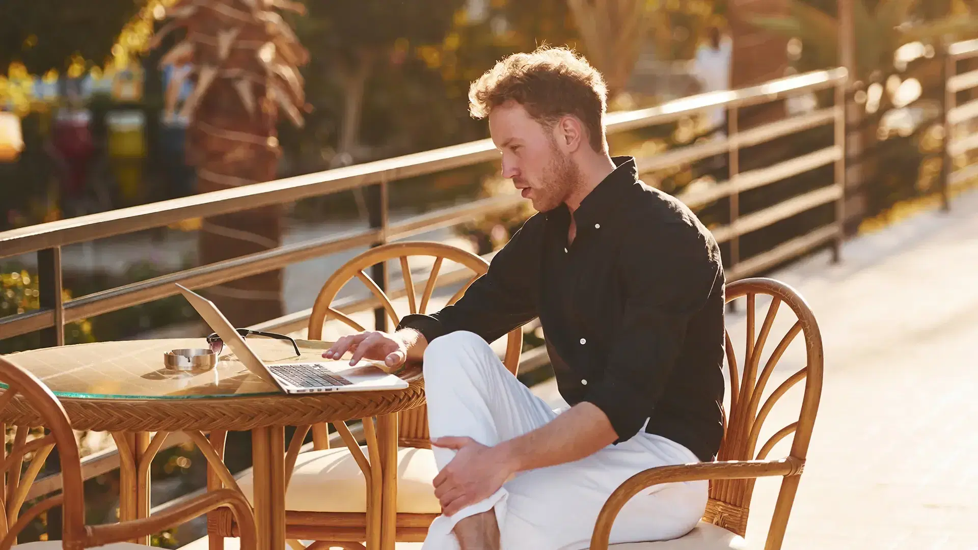 freelance working with his laptop in a terrace