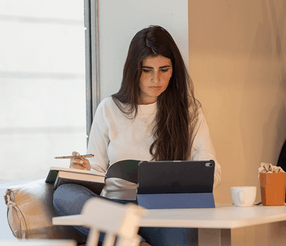 How It Works hero — freelancer with tablet