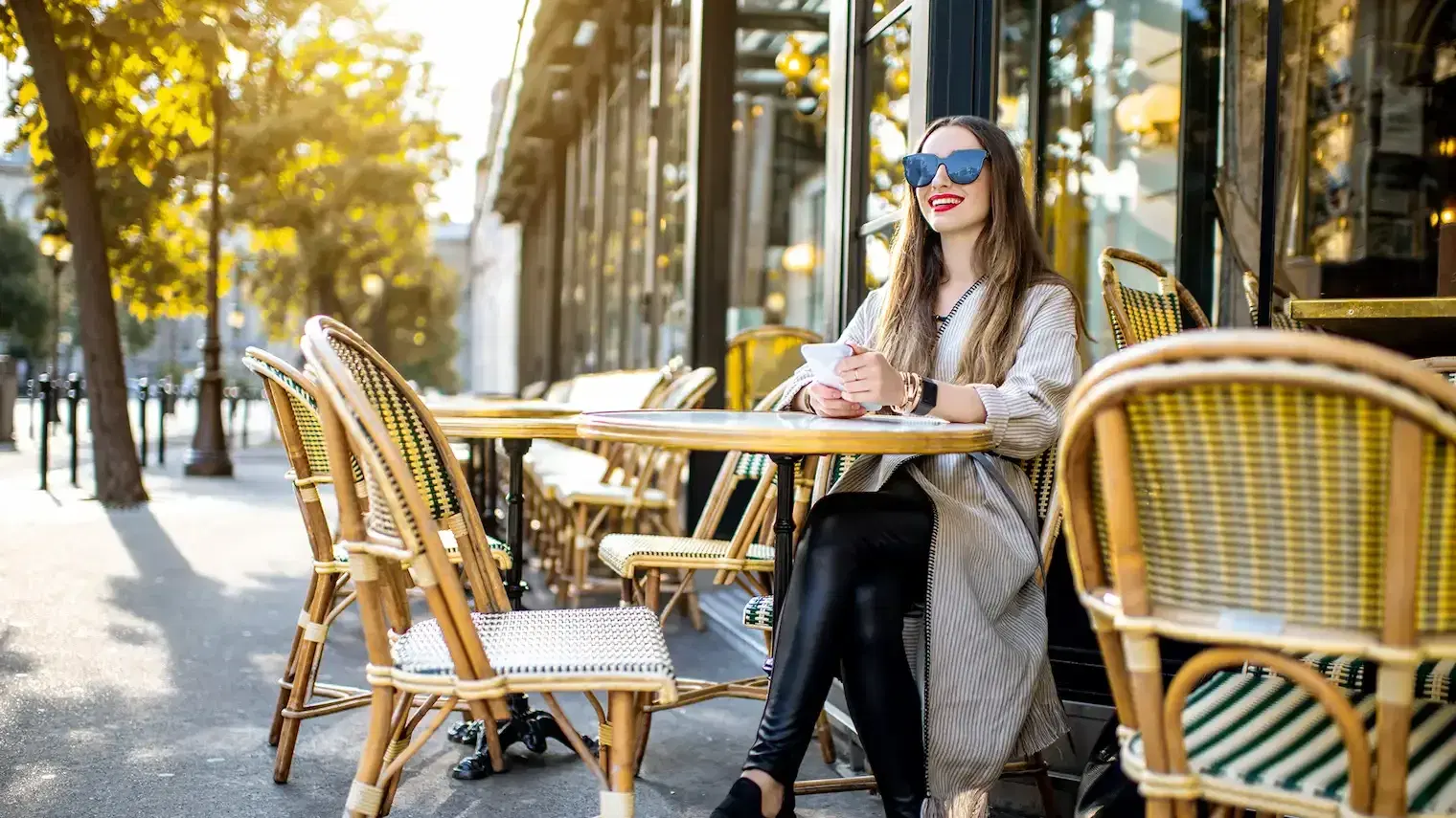 A freelance woman enjoying a coffee in a Parisian café