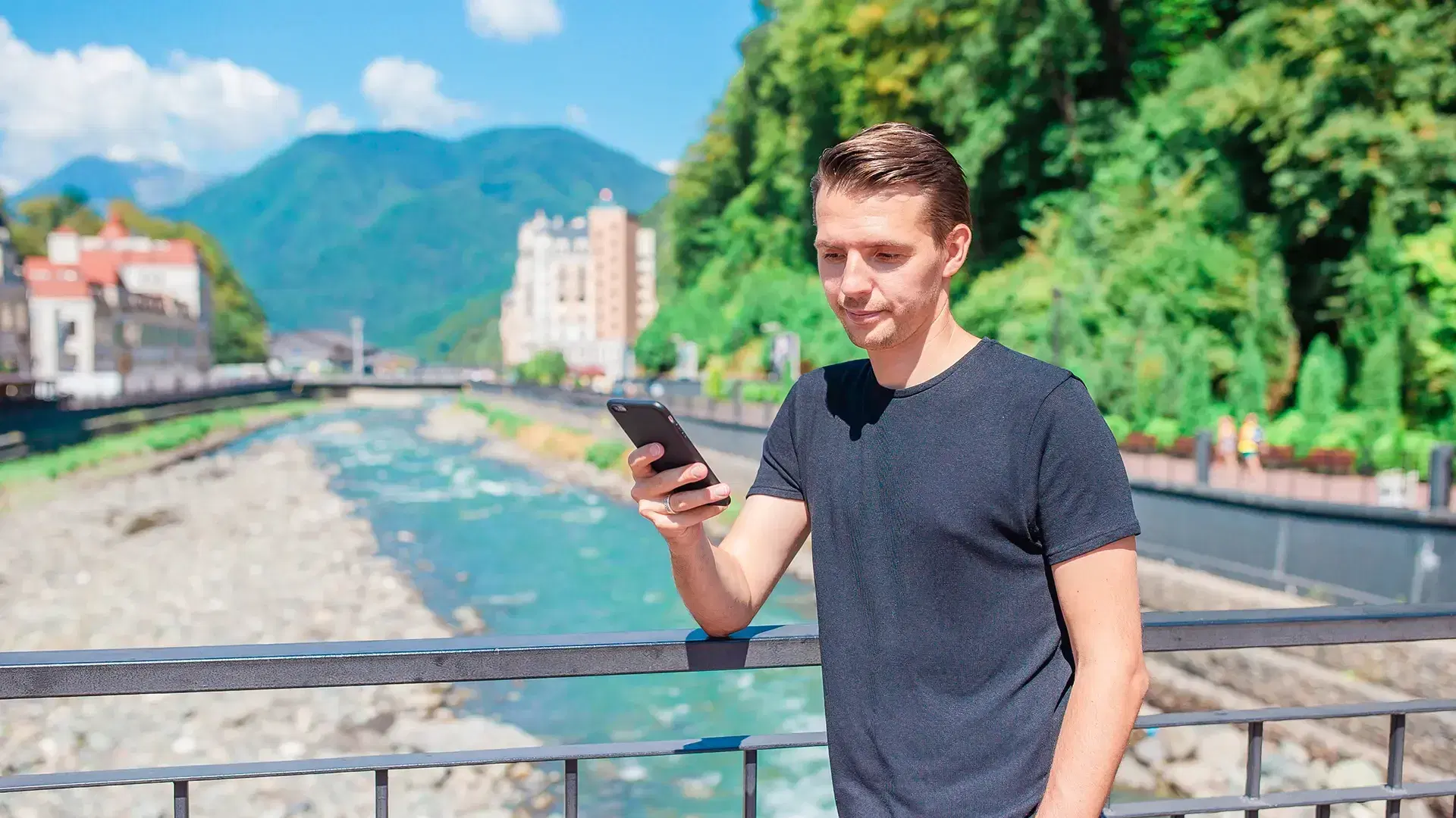 man checking his mobile phone with Swiss background