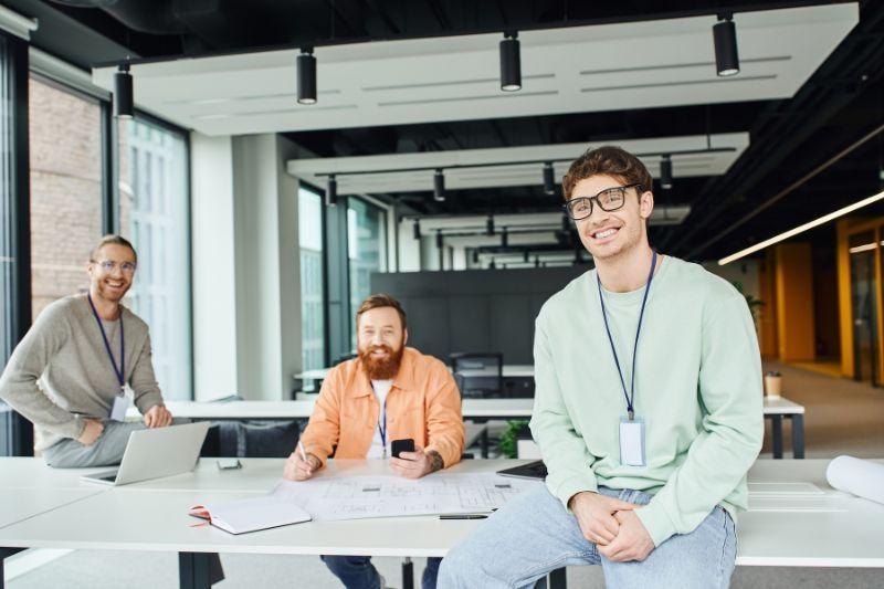 Three IT contractors working together in a modern office.