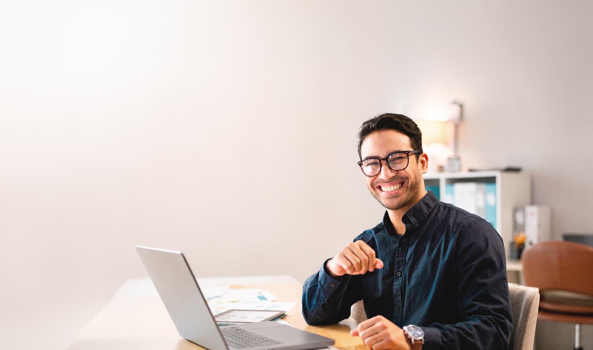 Happy freelancer working on his laptop