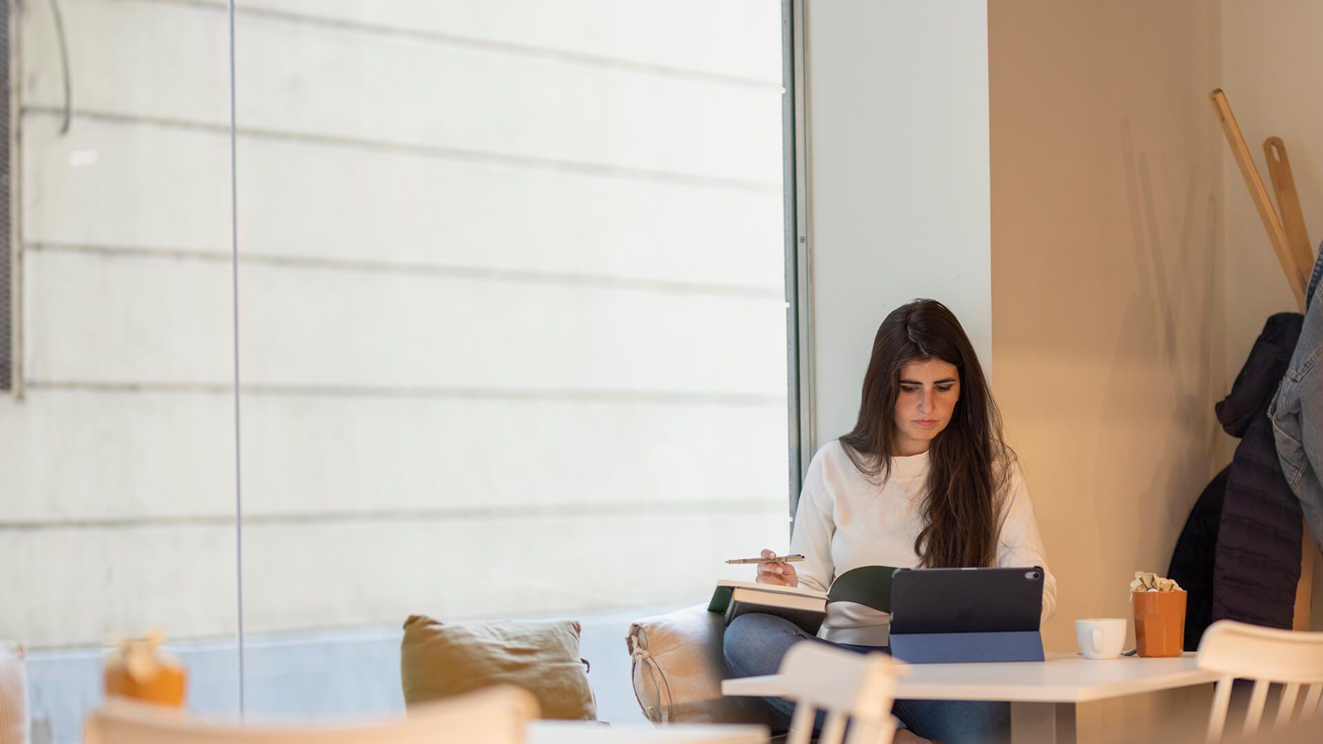 Woman working from her tablet at home