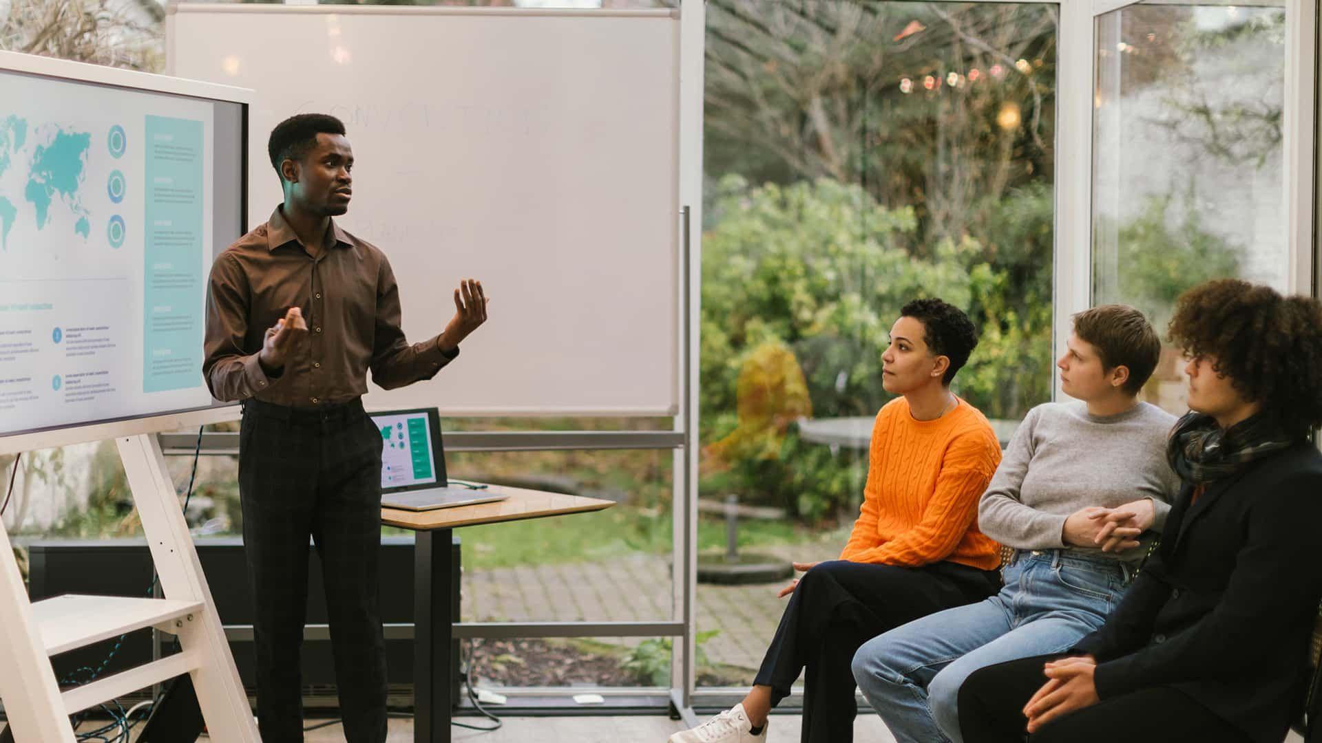 Business presentation, with four people.