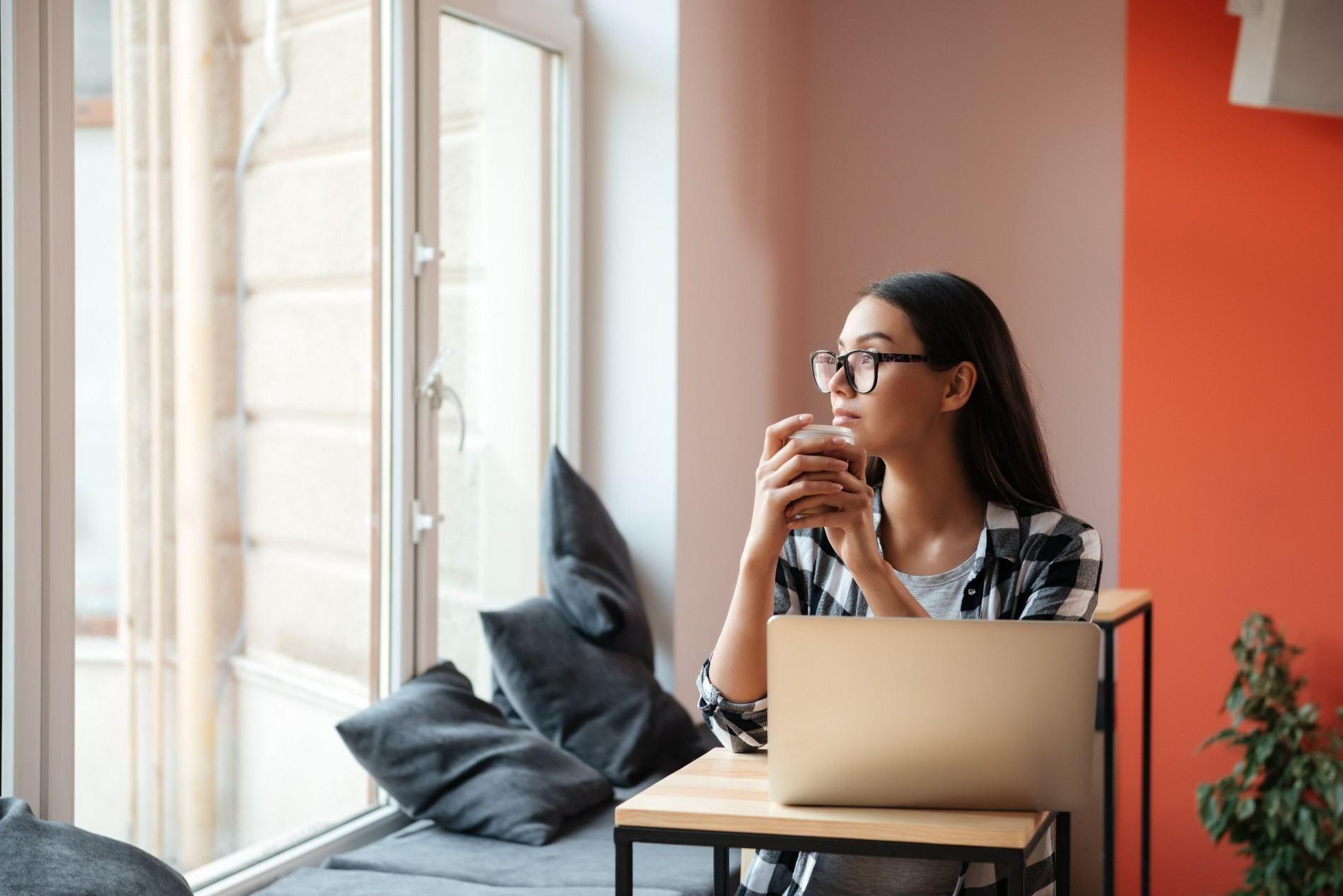 Relaxing Freelancer with Coffee by the Window.