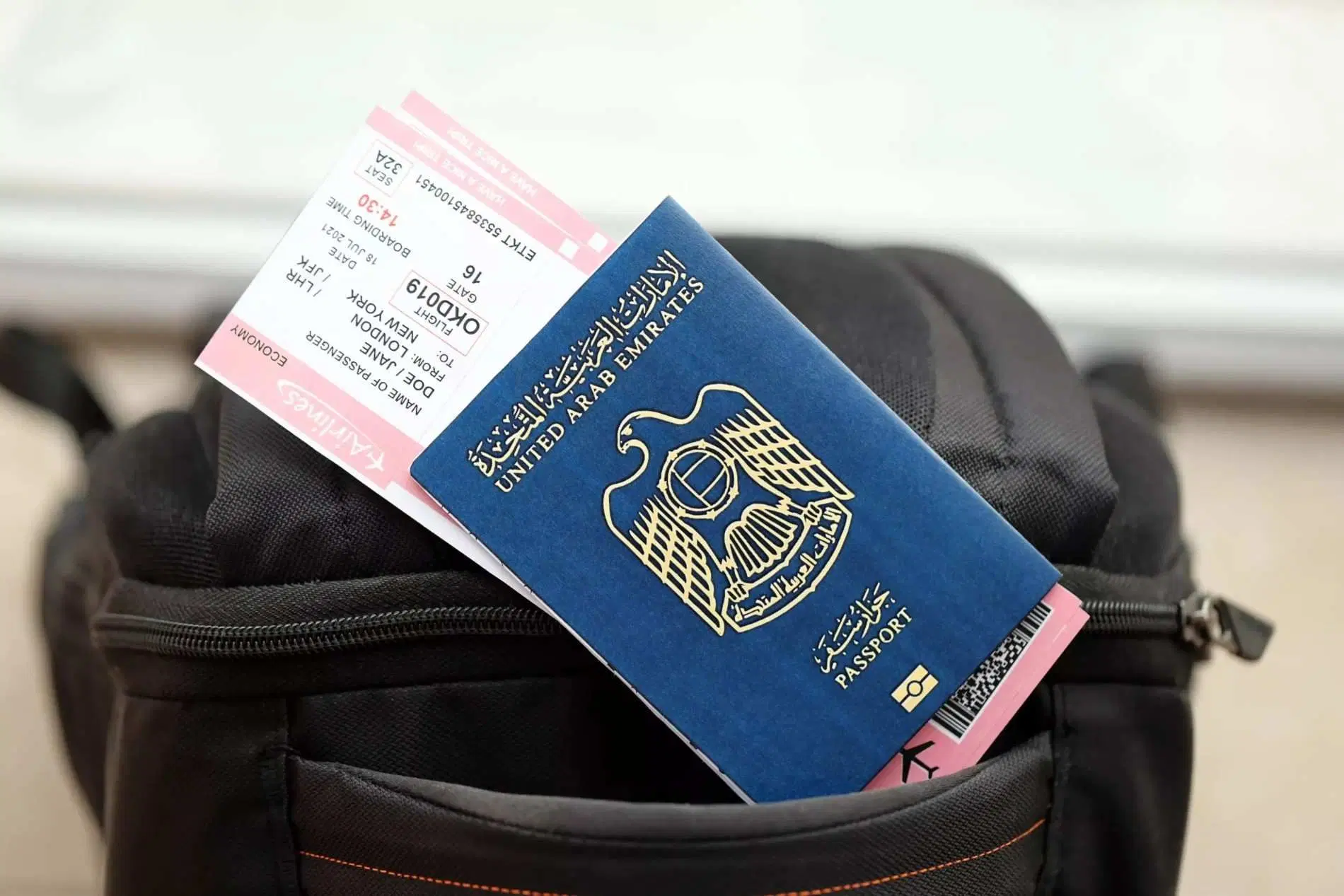 United Arab Emirates passport with an airline boarding pass on a travel bag.