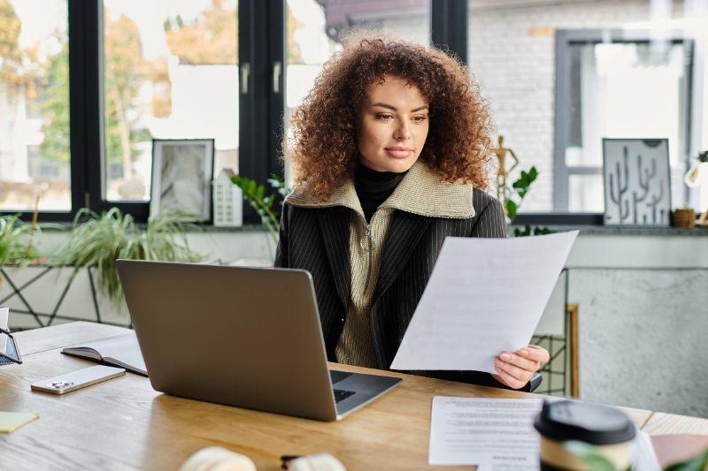 Professional reviewing employment documents before choosing an umbrella company.