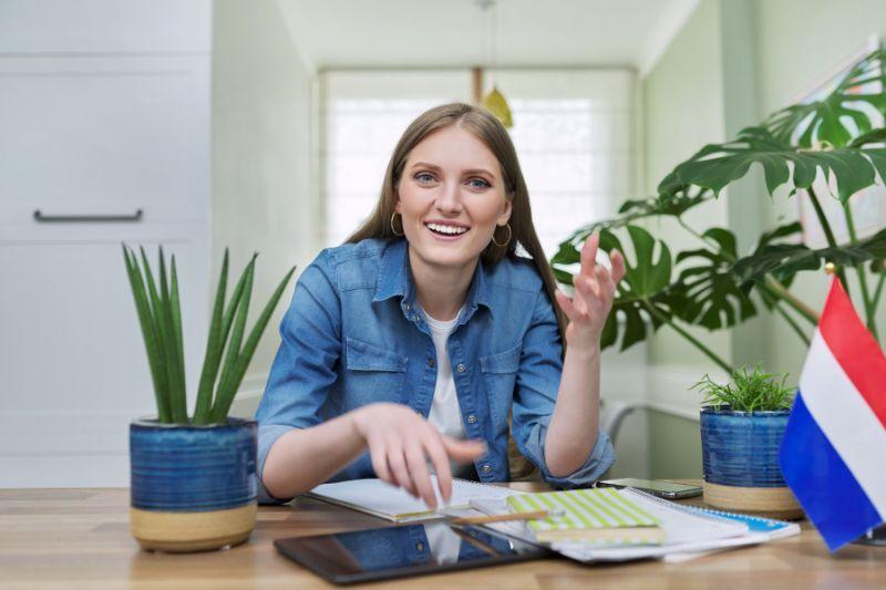 Freelancer working from a home office with a Dutch flag on the desk.