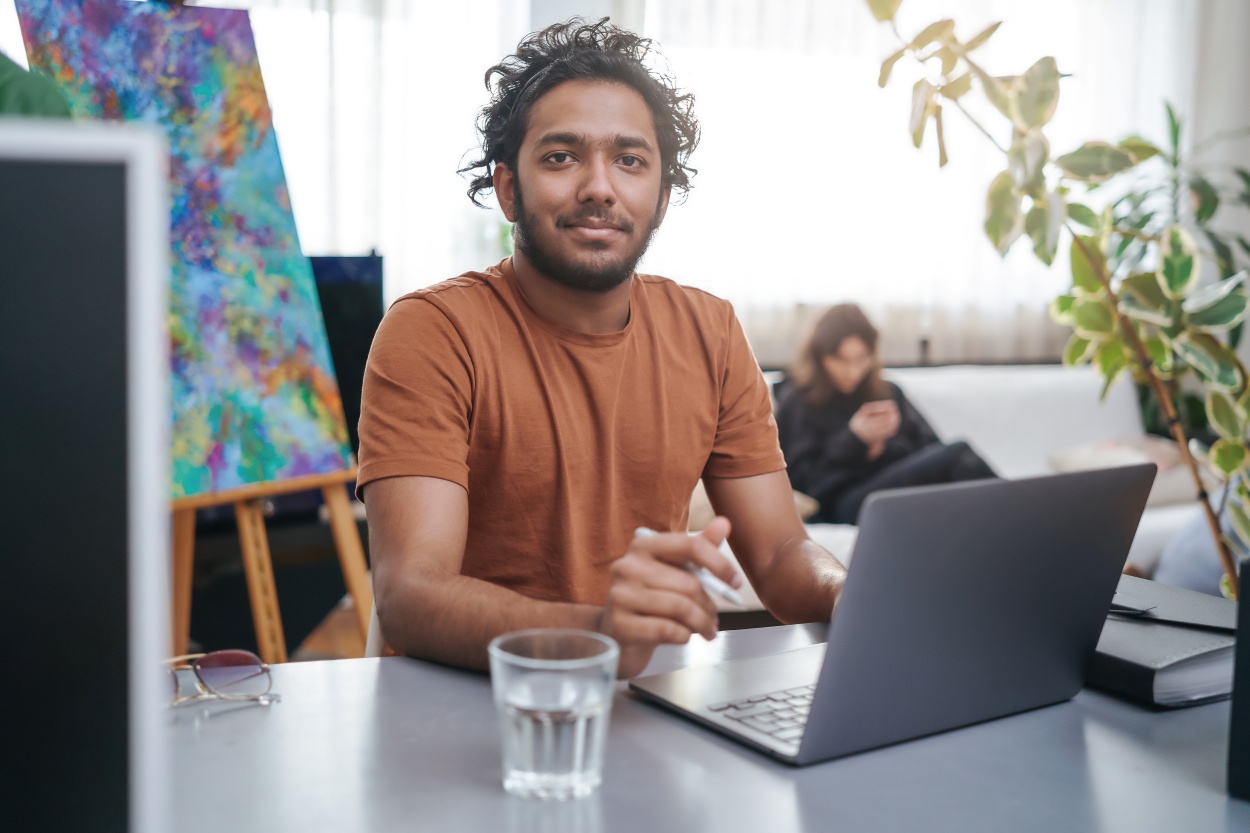 successful-guy-with-curly-hairs-works-using-a-lapt-2026-01-07-01-16-25-utc